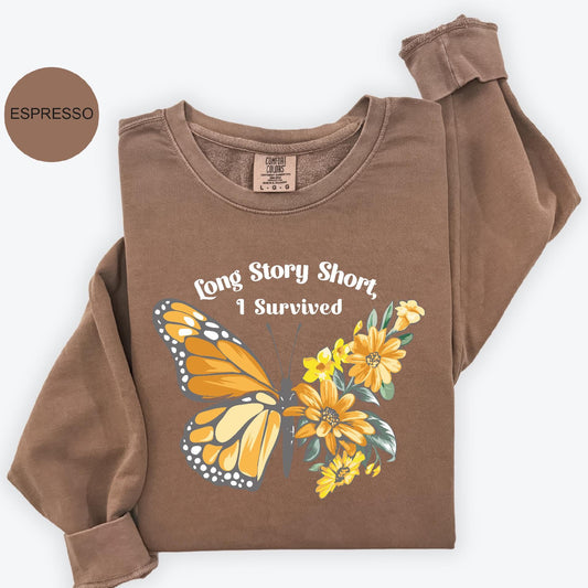 a brown shirt with a butterfly and flowers on it