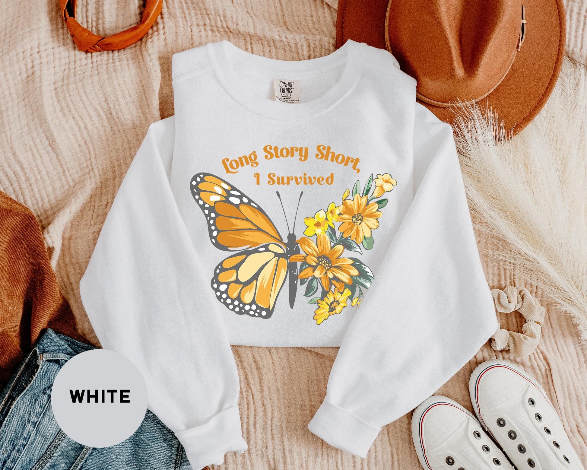a white shirt with a yellow butterfly on it