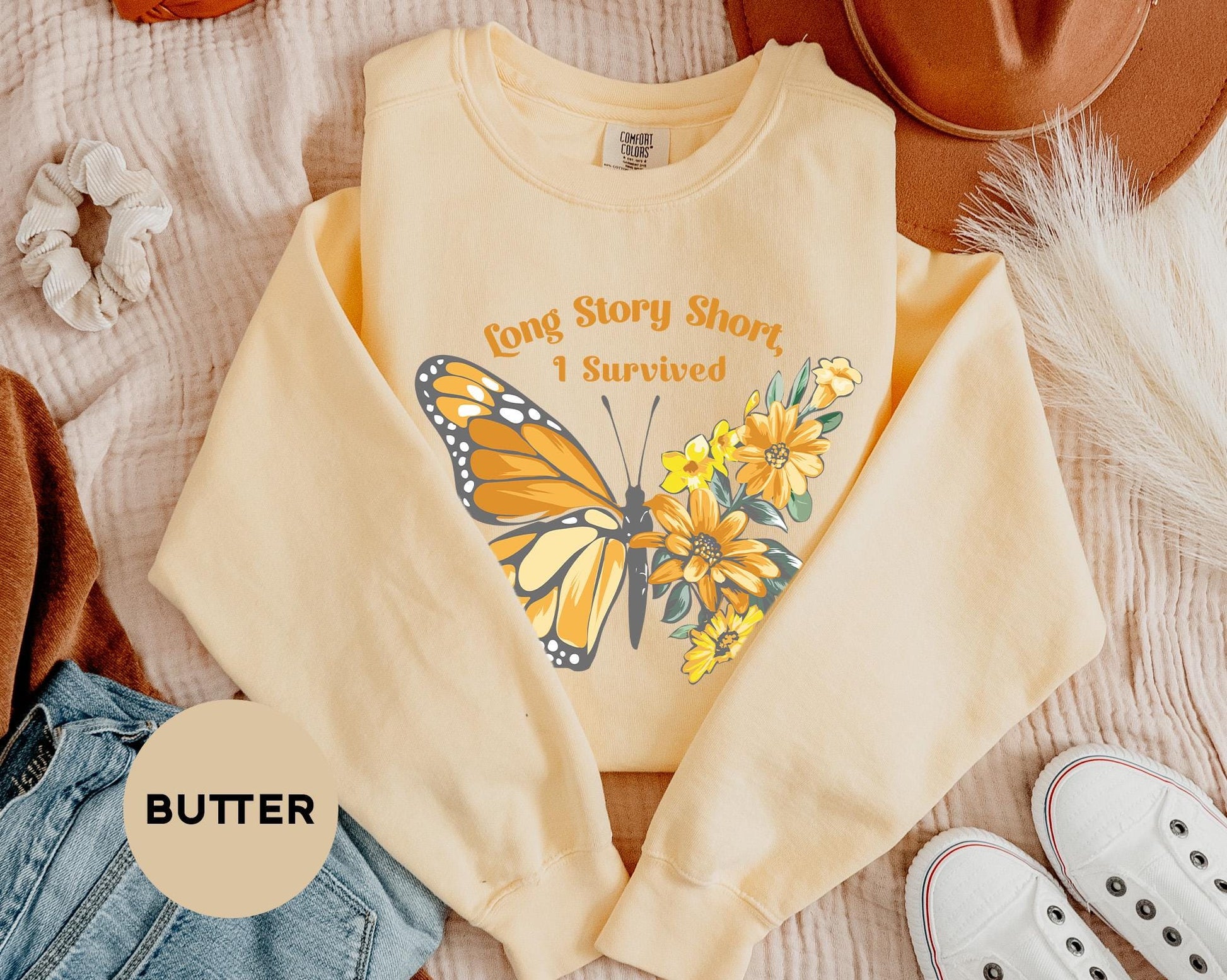 a yellow shirt with a butterfly on it