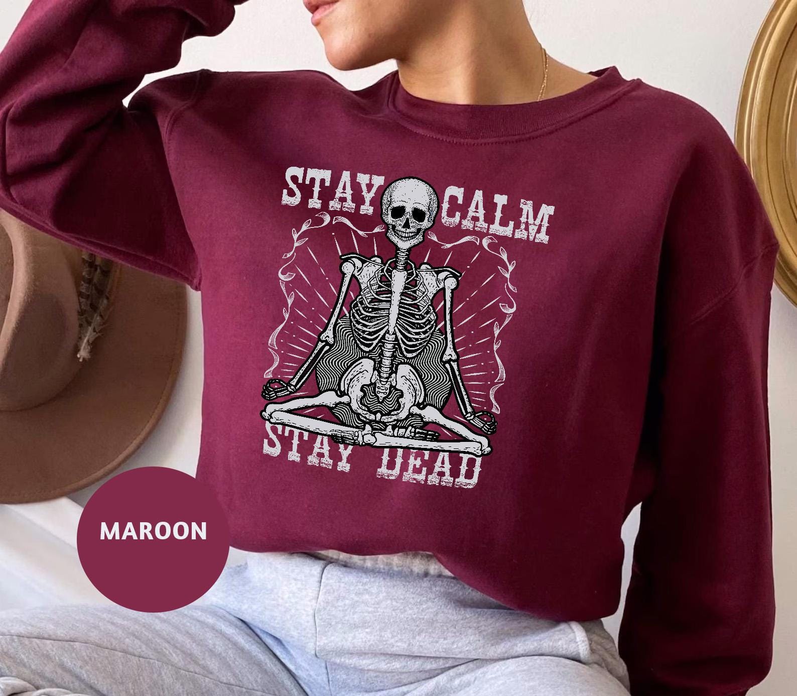 a woman wearing a sweatshirt with a skeleton on it