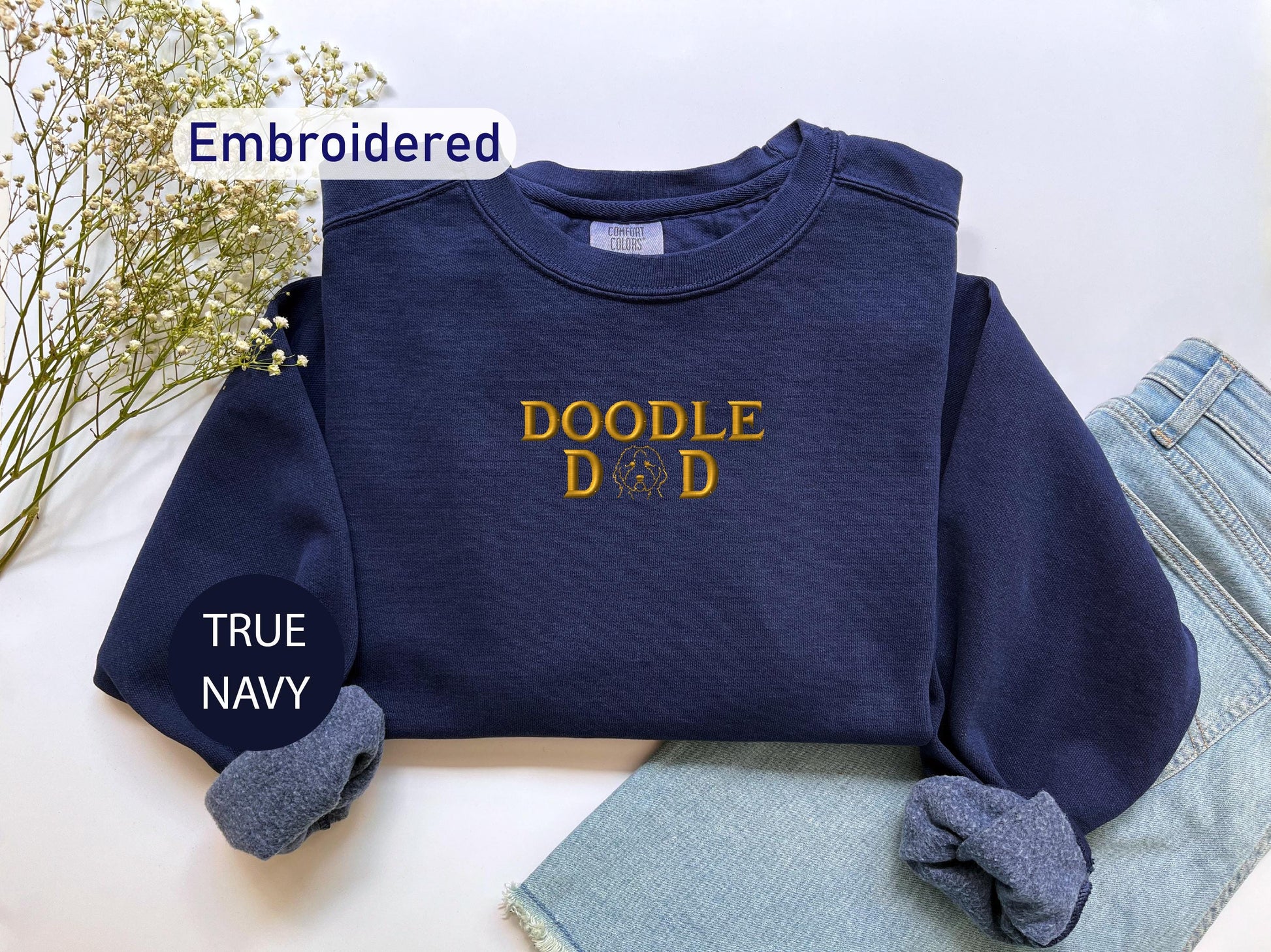 a t - shirt that says doodle do is next to a pair of jeans