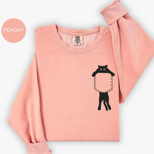 a pink shirt with a black cat on it