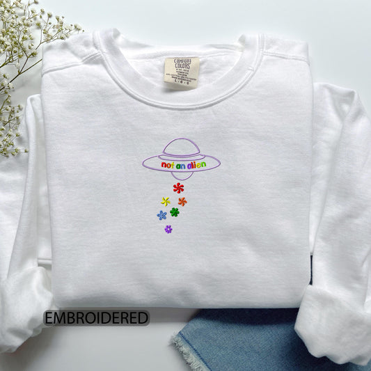a white shirt with a picture of a hat and flowers on it