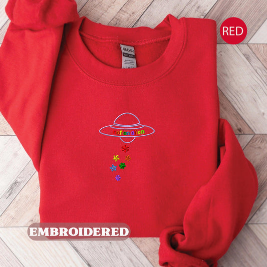 a red sweatshirt with a picture of an alien on it