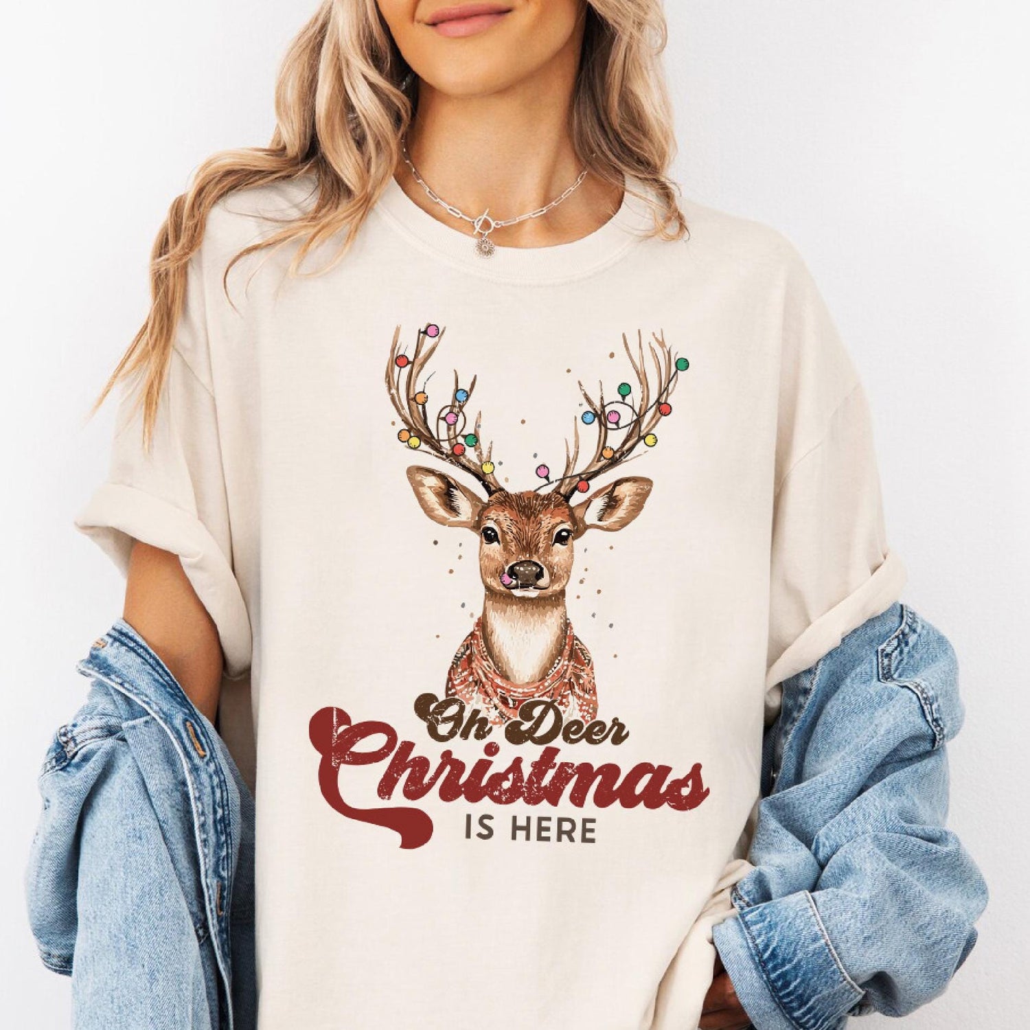 a woman wearing a t - shirt with a deer on it