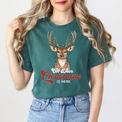 a woman wearing a green christmas t - shirt with a deer on it