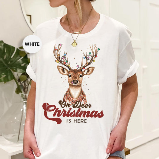 a woman wearing a white t - shirt with a deer on it