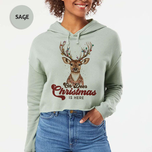 a woman wearing a christmas sweatshirt with a deer on it
