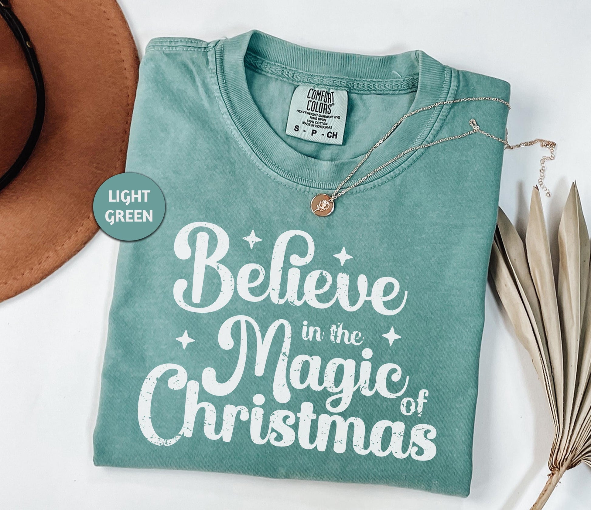 a t - shirt that says believe in the magic of christmas