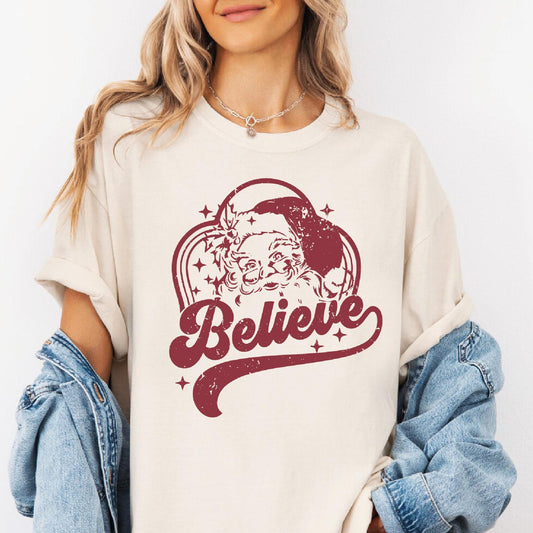 a woman wearing a t - shirt that says believe