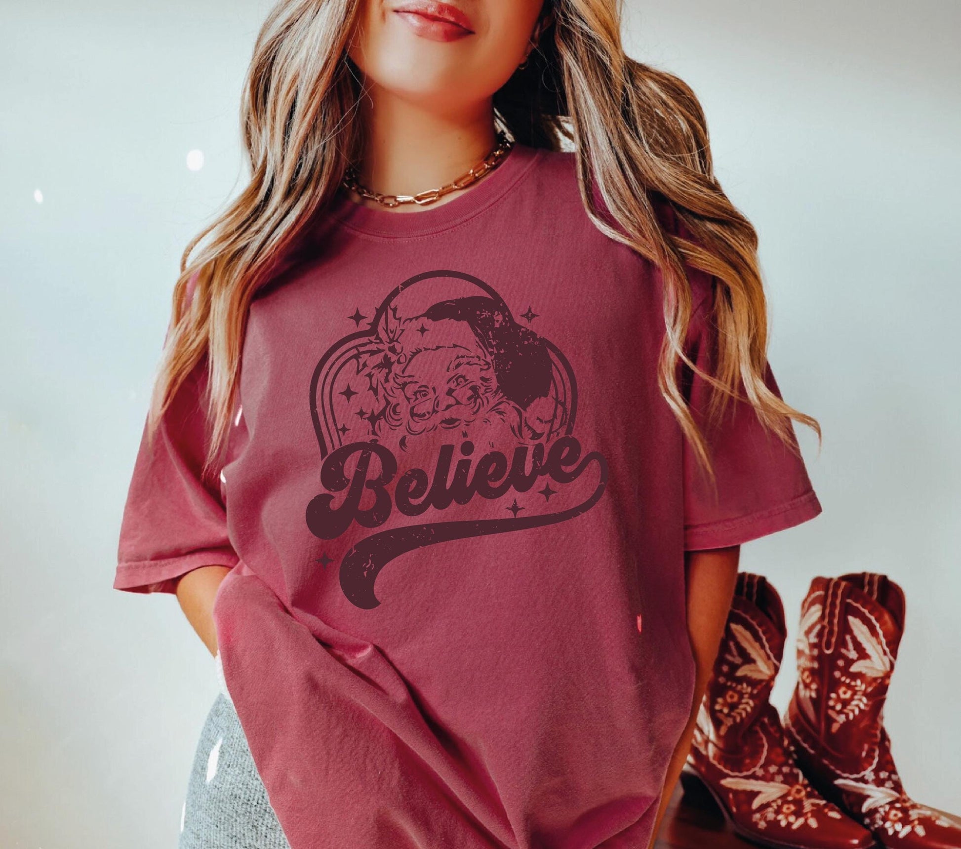 a girl wearing a t - shirt that says believe