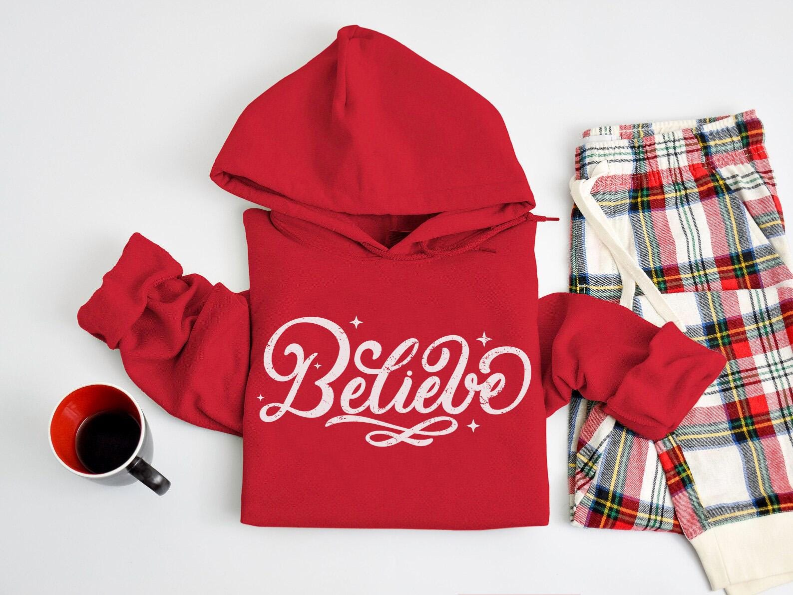 a red hoodie with the word believe written on it