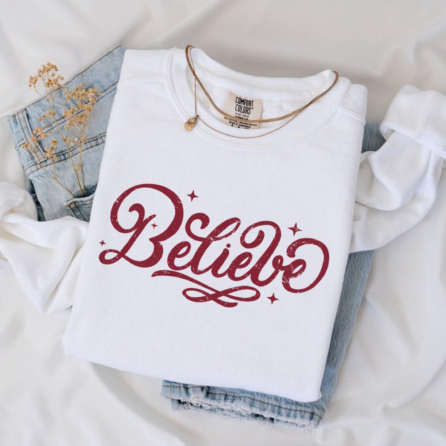 a white shirt that says believe on it