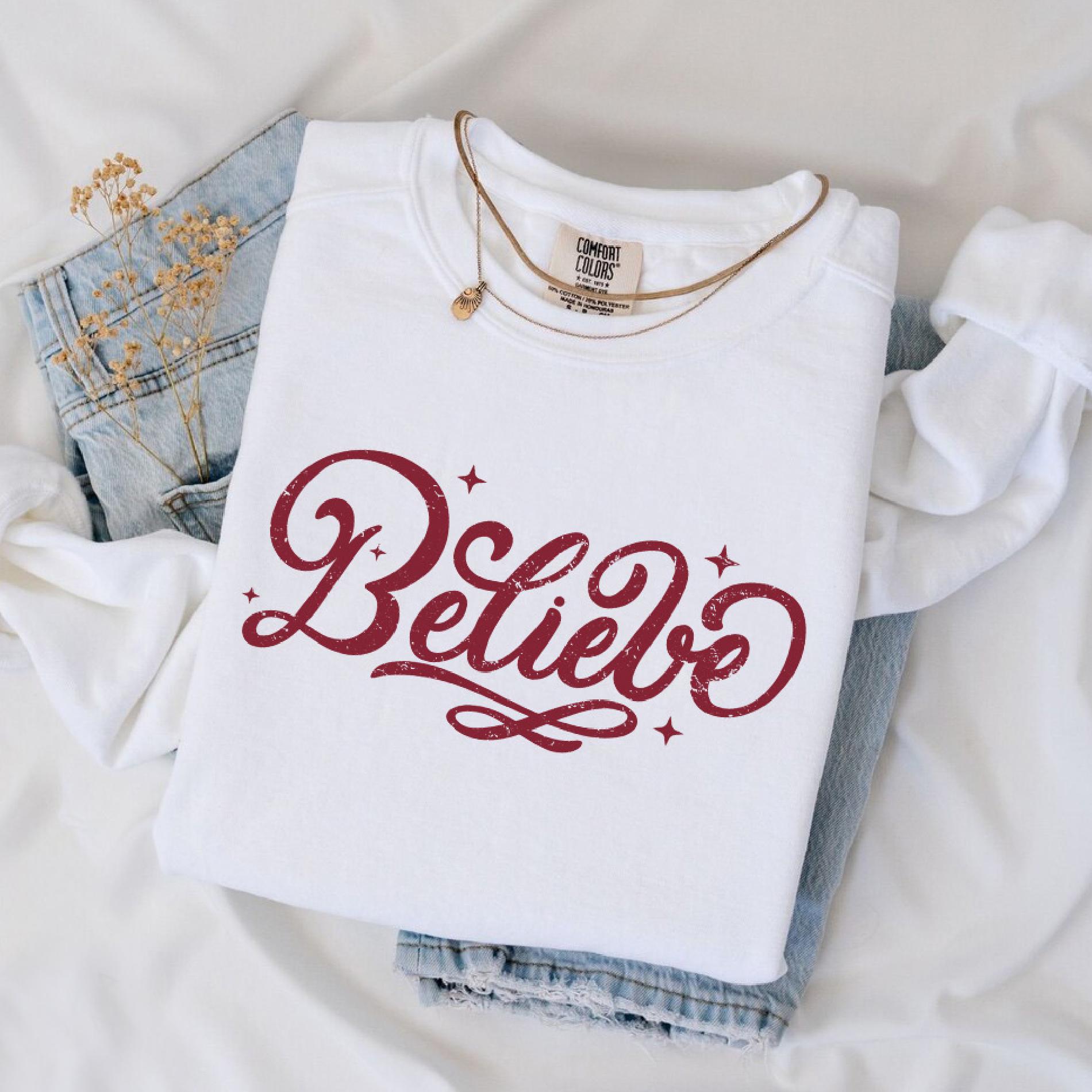 a white shirt that says believe on it