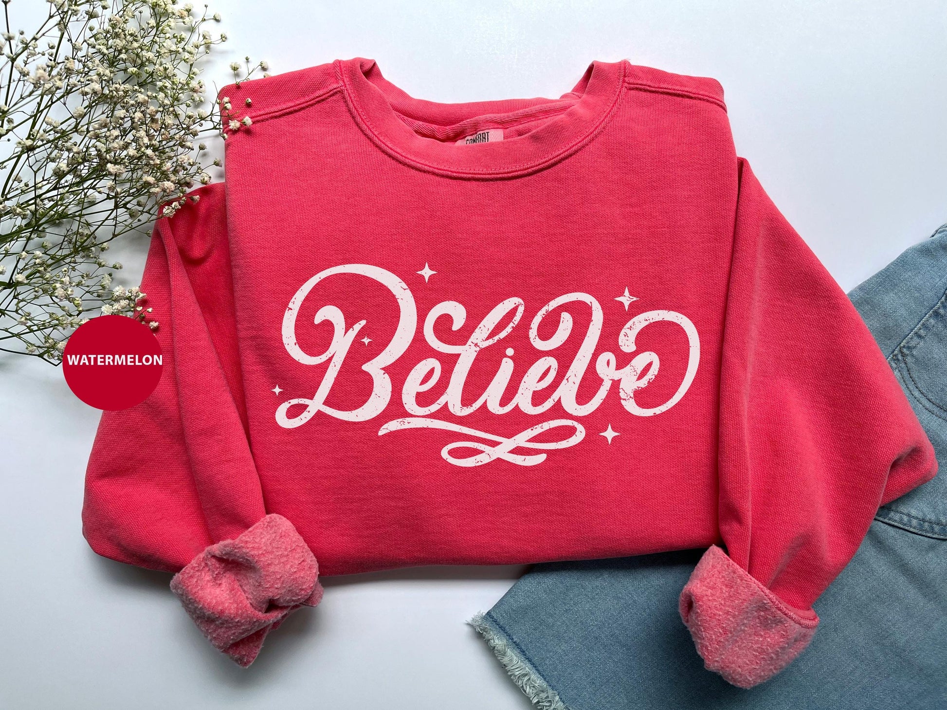 a red sweatshirt with the words believe on it