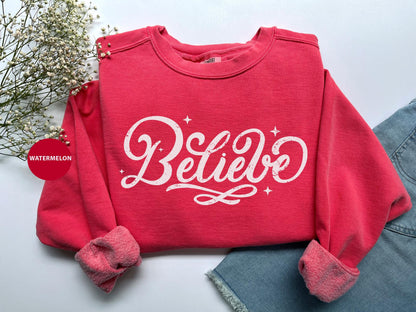 a red sweatshirt with the words believe on it