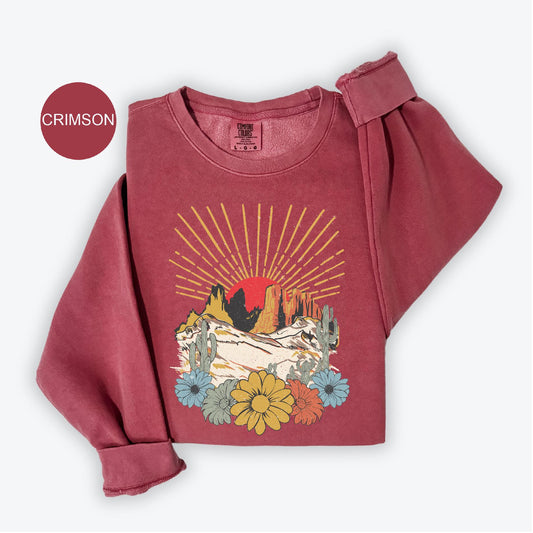a red shirt with a mountain scene on it