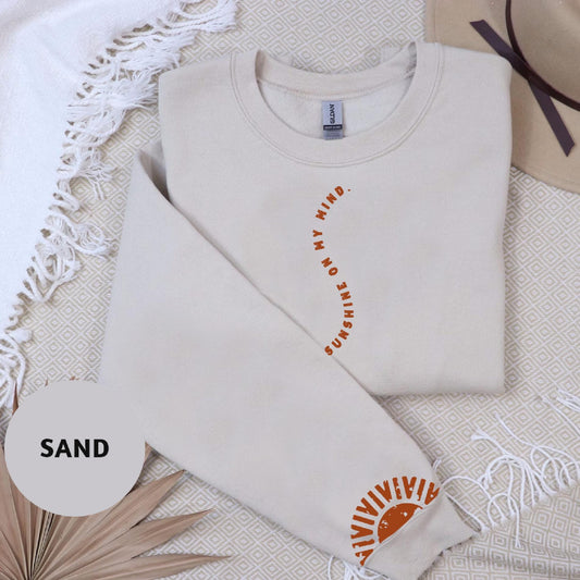 a white t - shirt with an orange design on it
