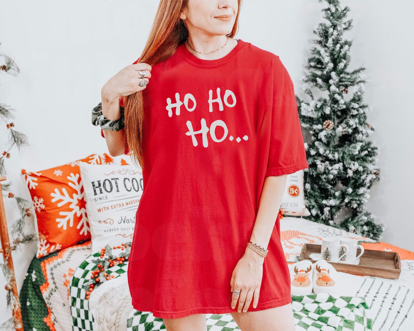 a woman standing in front of a christmas tree