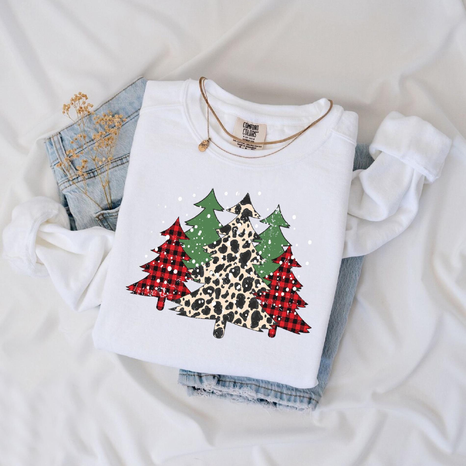 a white shirt with a leopard print christmas tree on it