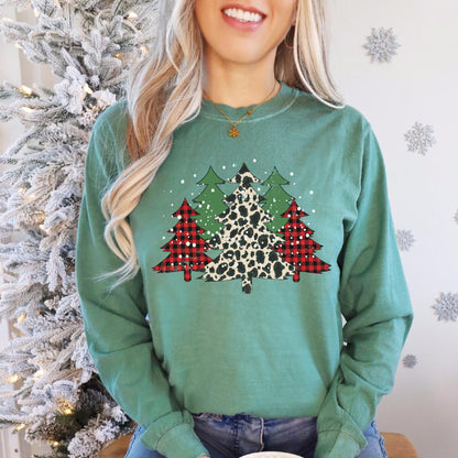 a woman wearing a green sweater with a leopard print christmas tree on it