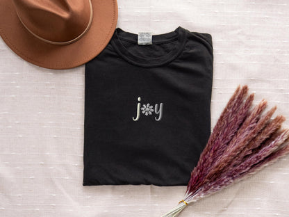 a hat, t - shirt, and dried grass on a bed