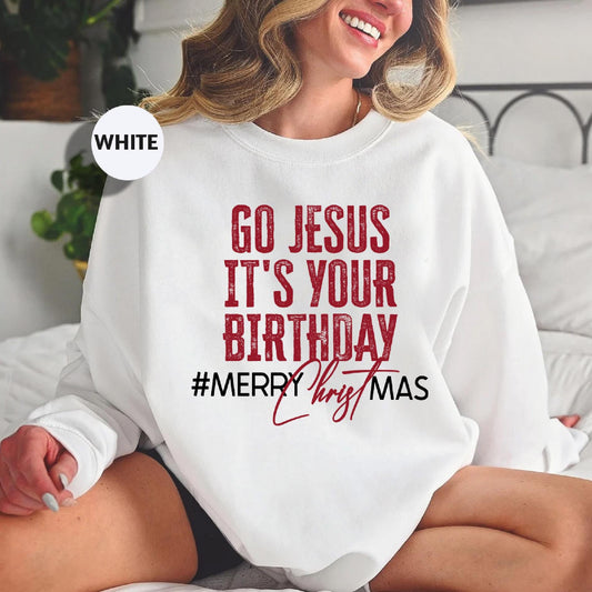 a woman sitting on a bed wearing a sweatshirt that says go jesus it's