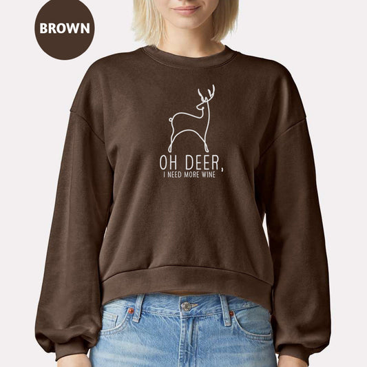 a woman wearing a brown sweatshirt with a deer on it