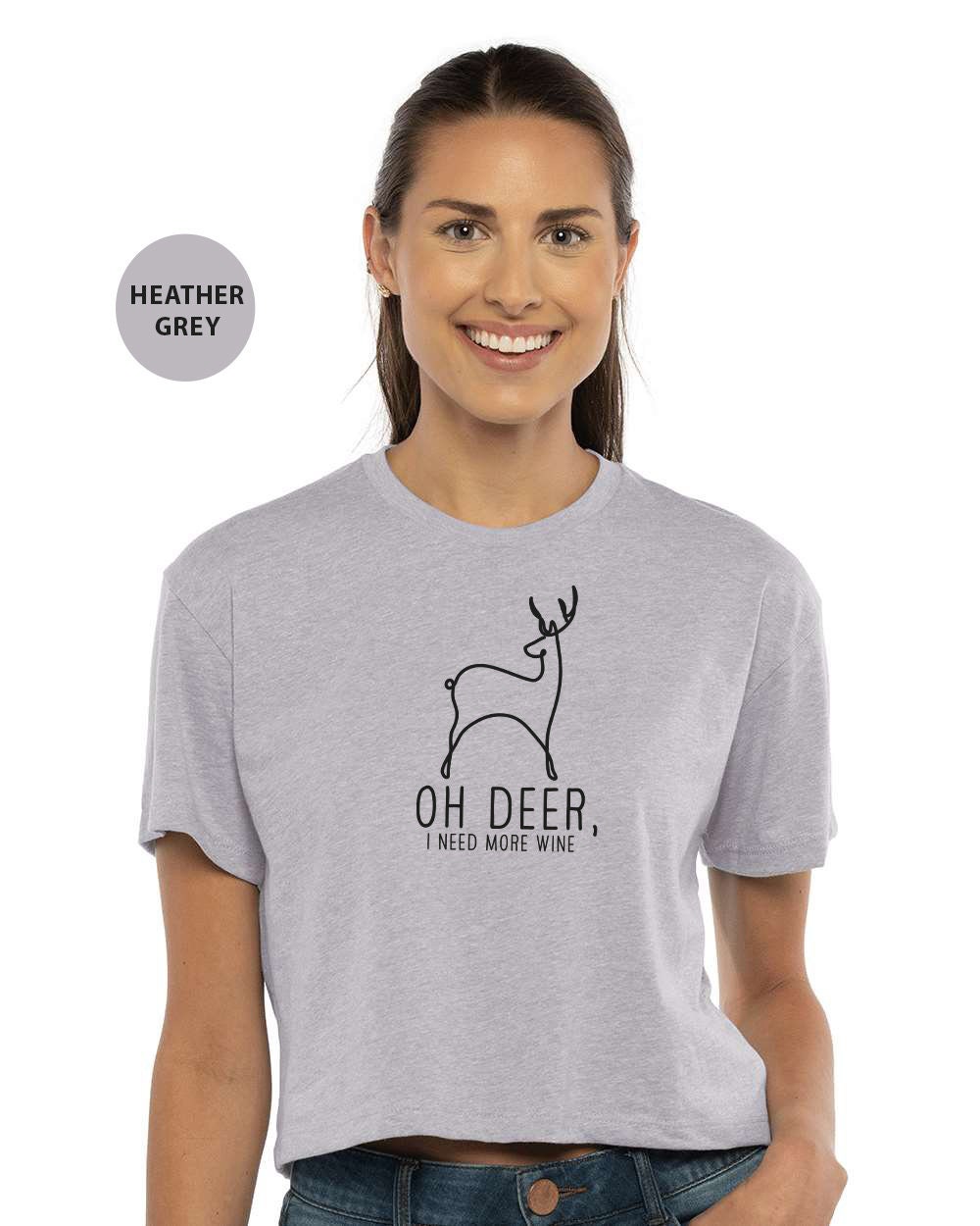 a woman wearing a grey shirt with a deer on it