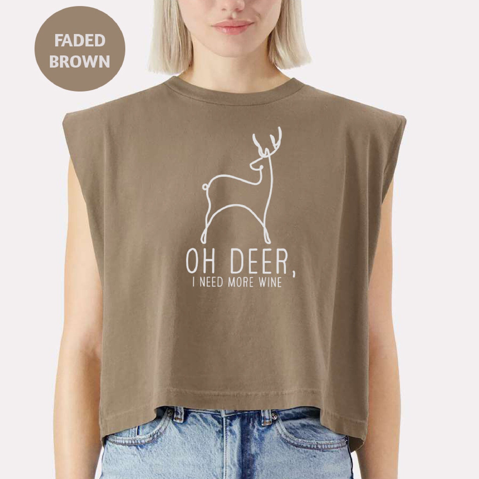 a woman wearing a brown shirt with a deer on it