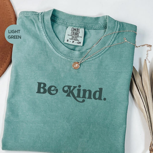a t - shirt with the words be kind on it