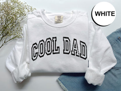 a white sweatshirt with the word cool dad printed on it