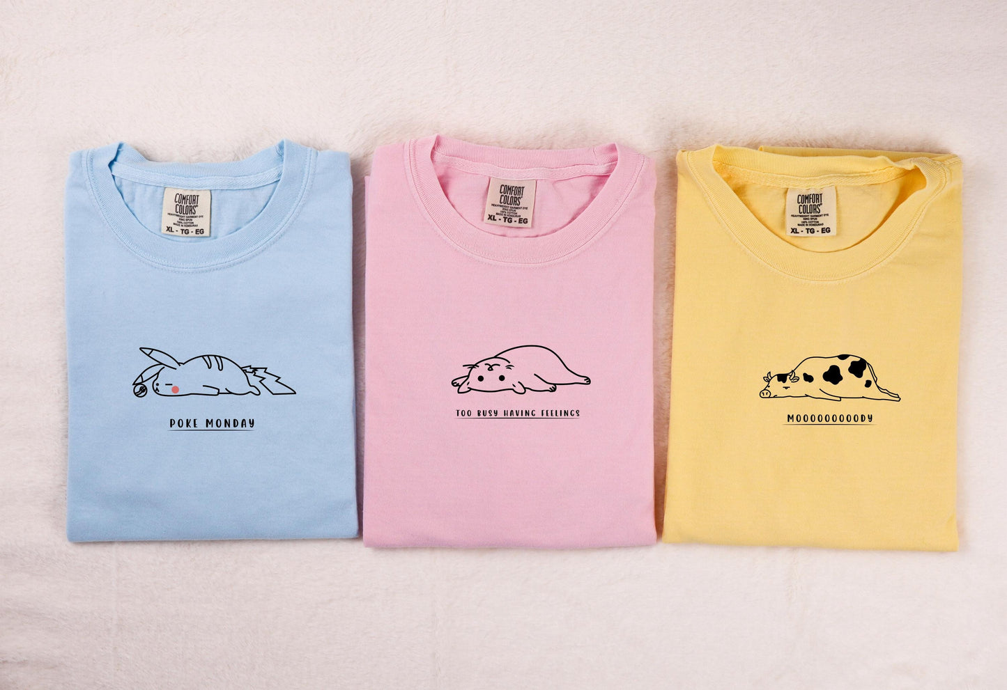 three t - shirts with animals on them on a white background