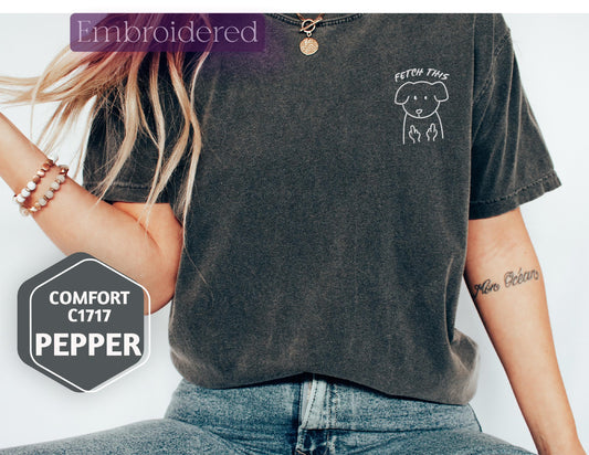 a woman wearing a black shirt with a dog on it