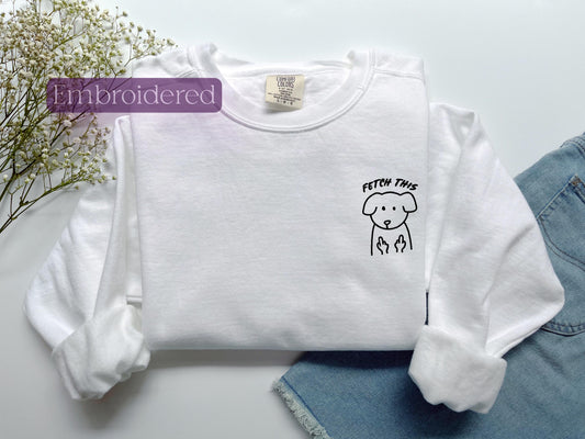 a white shirt with a dog drawn on it