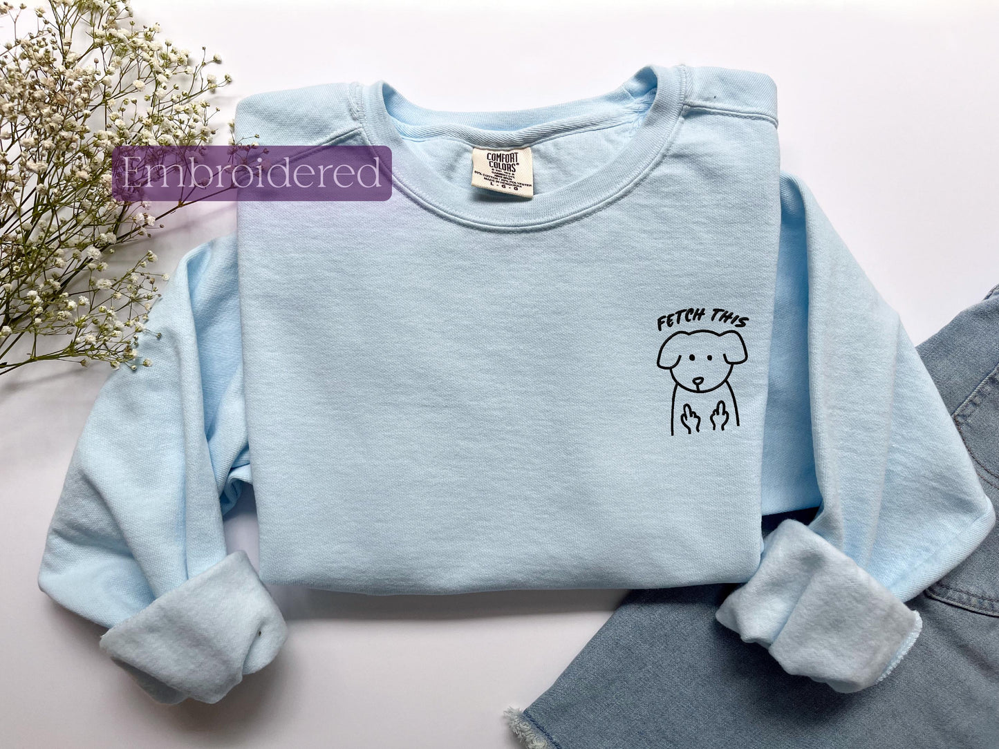 a blue shirt with a drawing of a dog on it