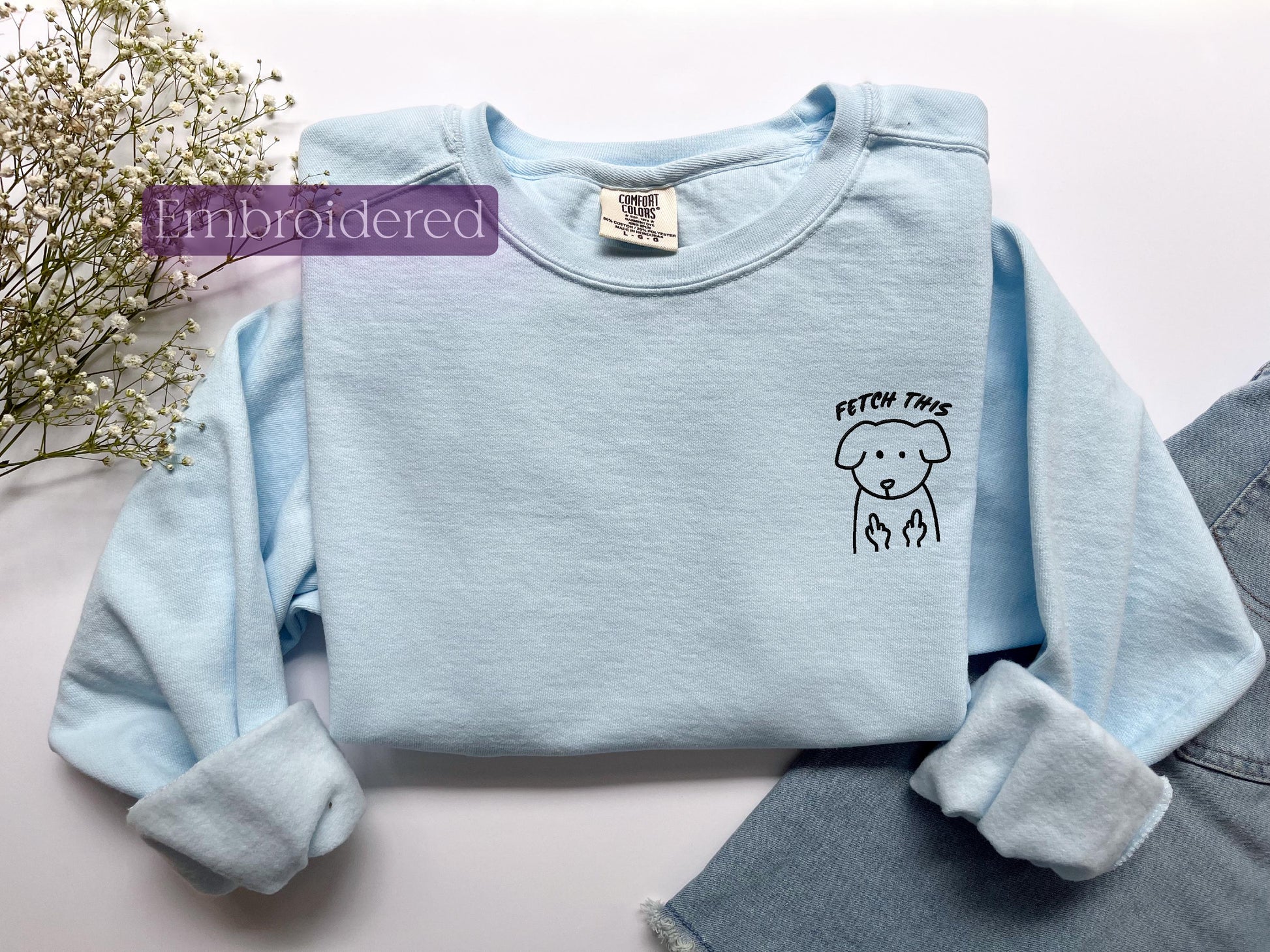 a blue shirt with a drawing of a dog on it