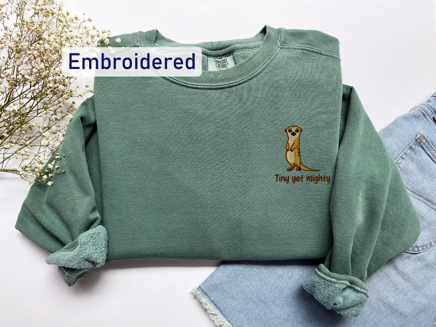 a green sweatshirt with a dog embroidered on it