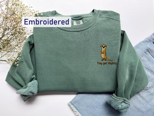a green sweatshirt with a dog embroidered on it