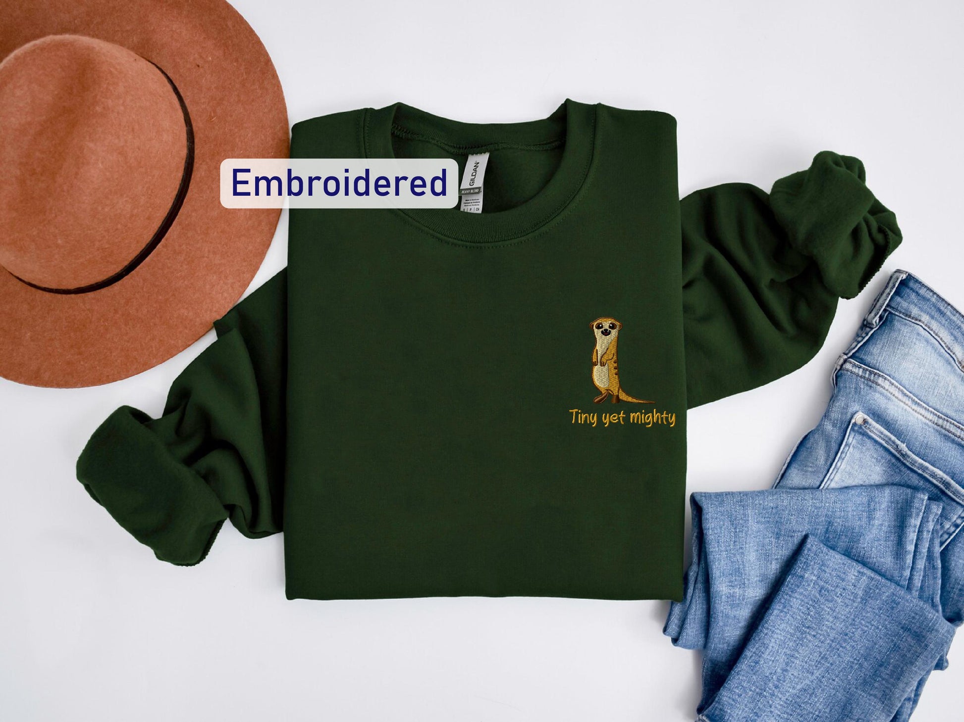 a green shirt with a kangaroo on it and a hat next to it