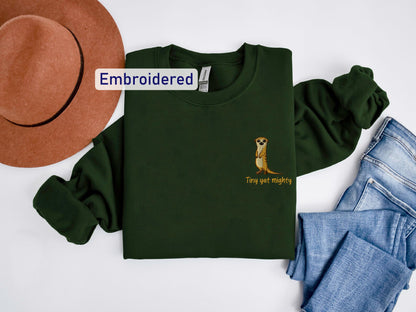 a green shirt with a kangaroo on it and a hat next to it