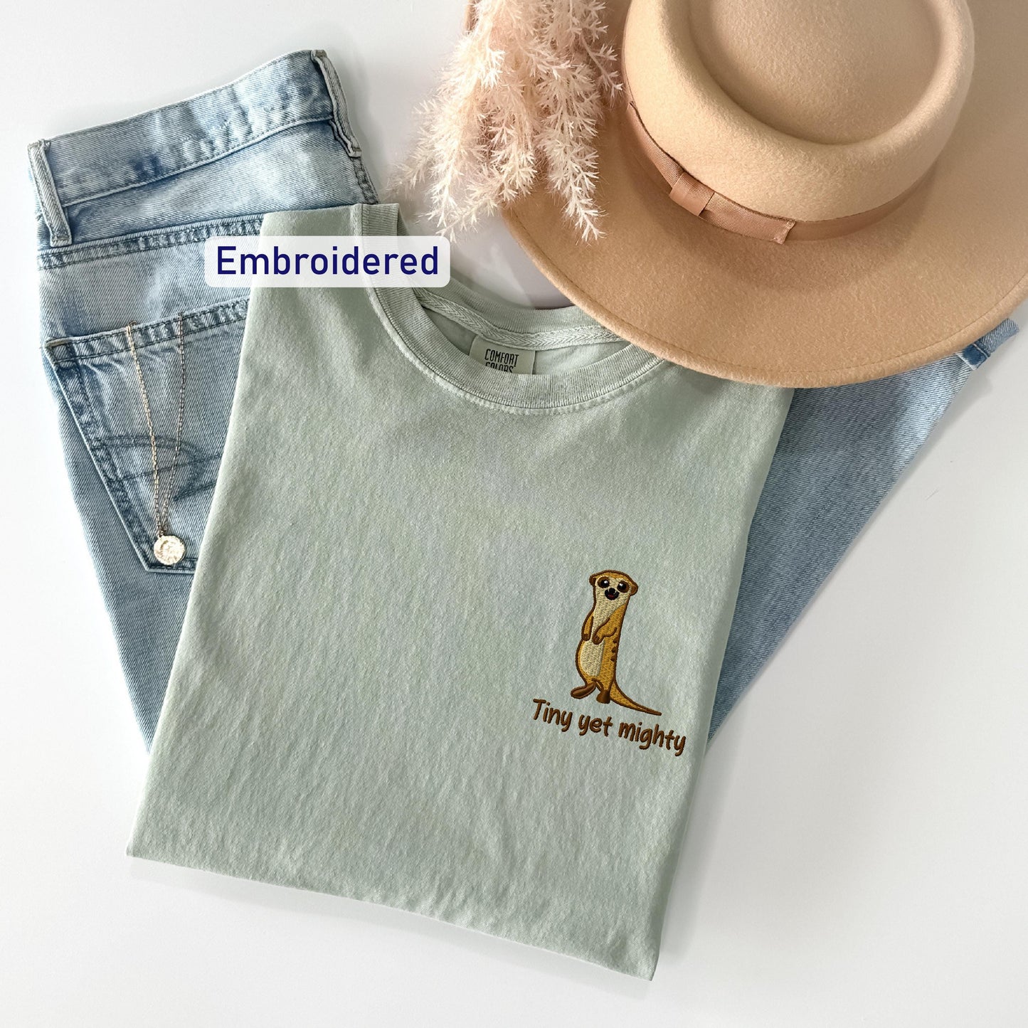 a hat, jeans, and a t - shirt on a white surface