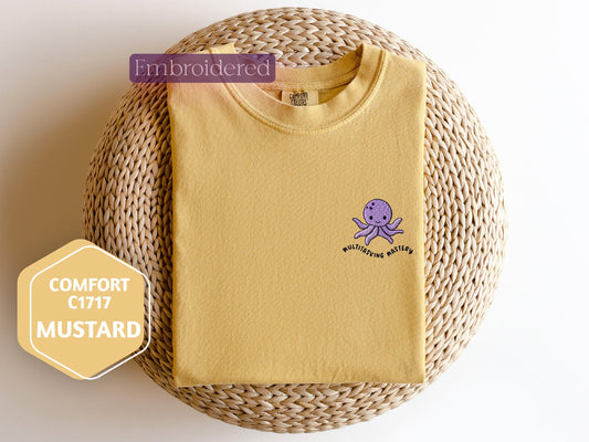 a yellow shirt with an octopus embroidered on it