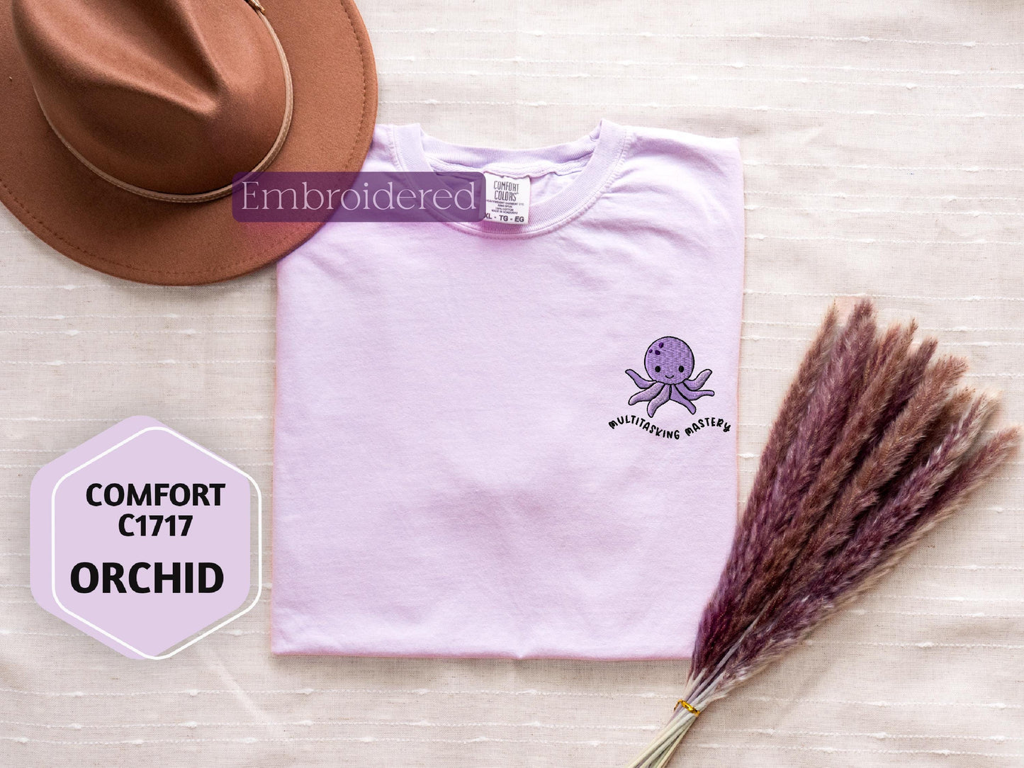 a t - shirt with an octopus on it next to a hat
