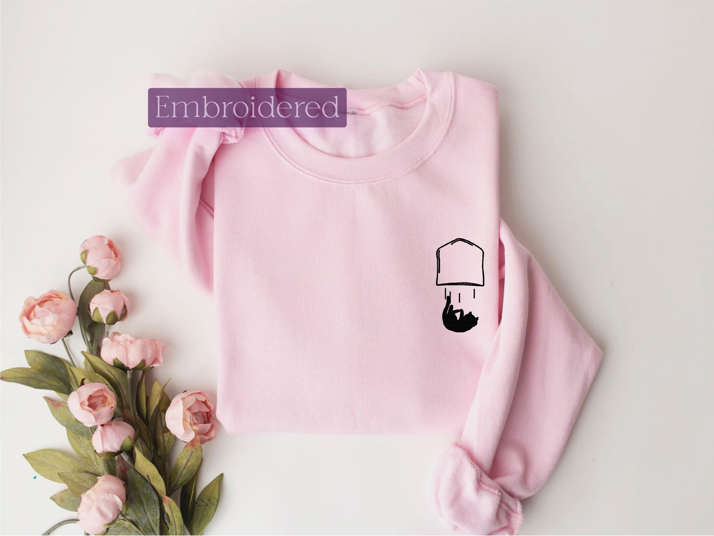 a pink sweater with a picture of a chef on it