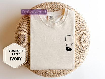 a white t - shirt with a picture of a lamp on it