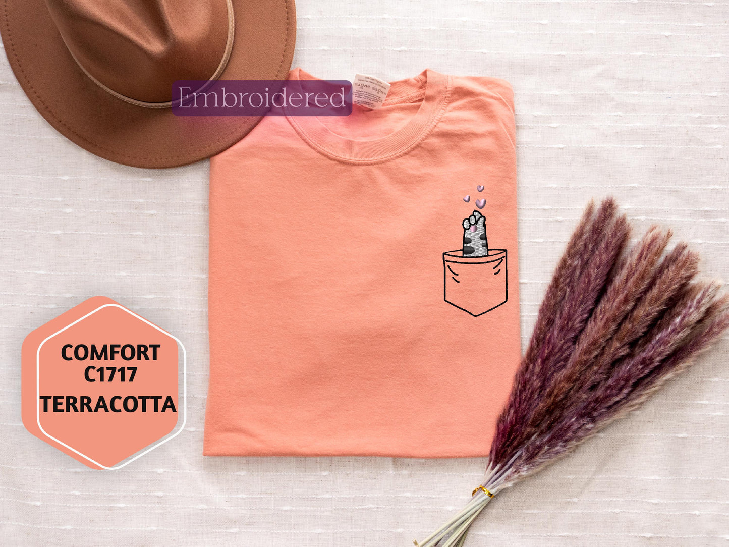 a t - shirt with a picture of a cactus in a pocket and a hat