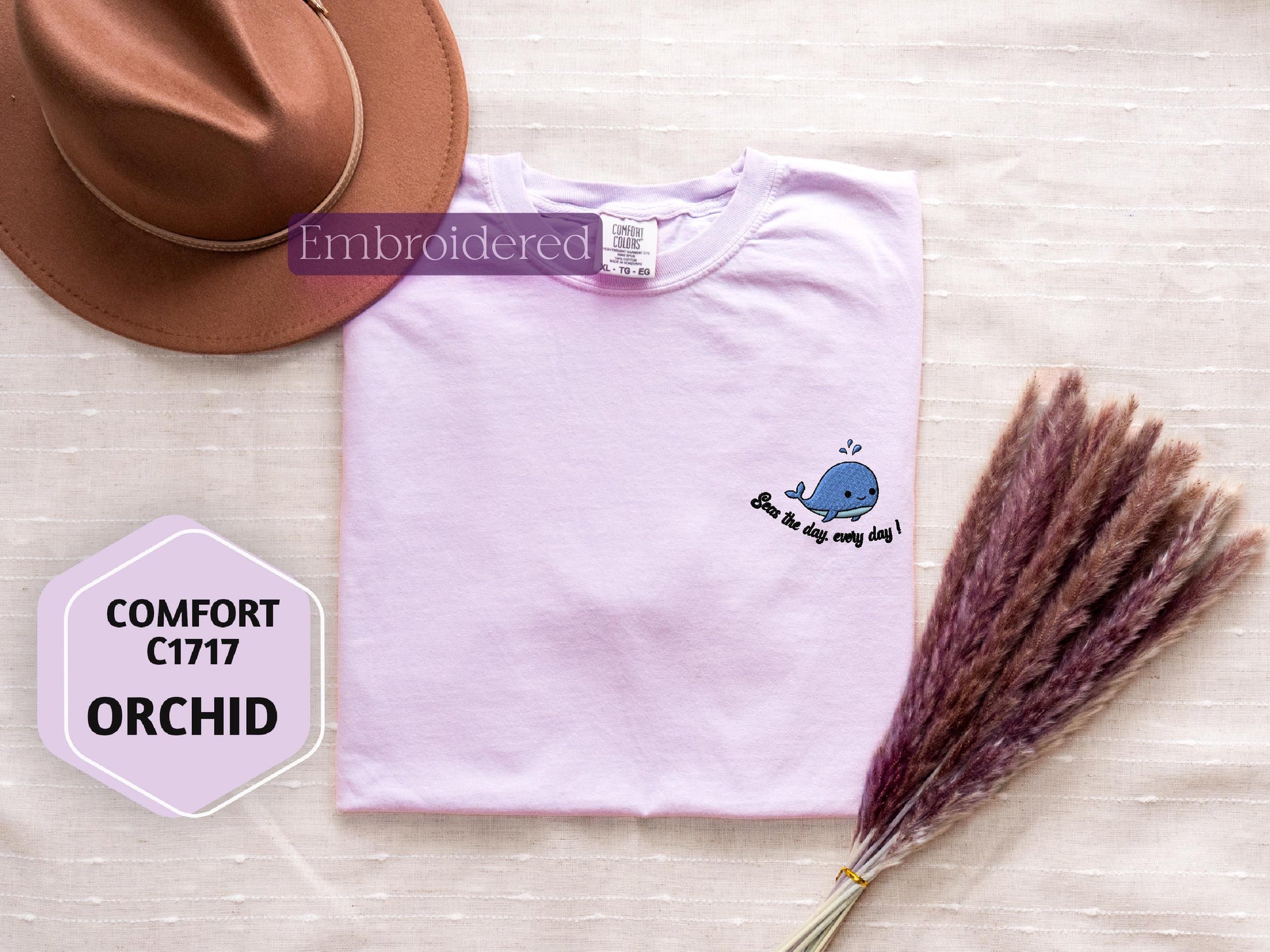 a hat, t - shirt, and dried grass on a table