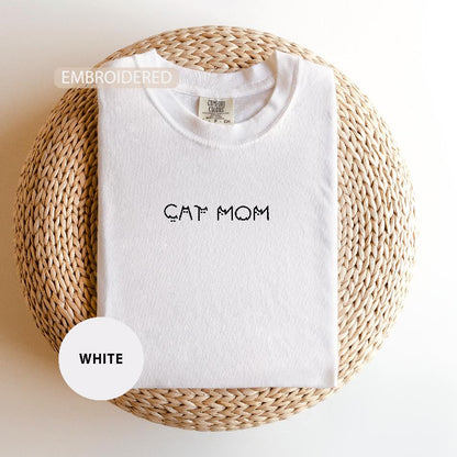 a white t - shirt with the word cat mom printed on it