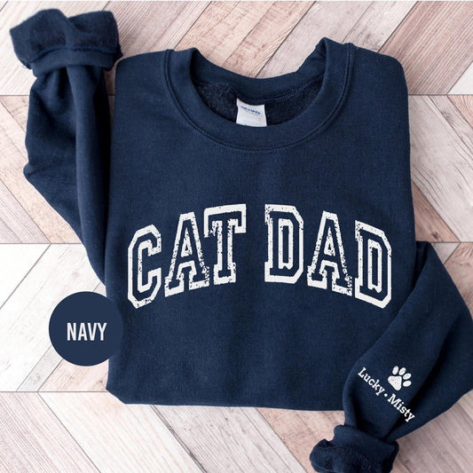 a navy sweatshirt with the word cat dad printed on it